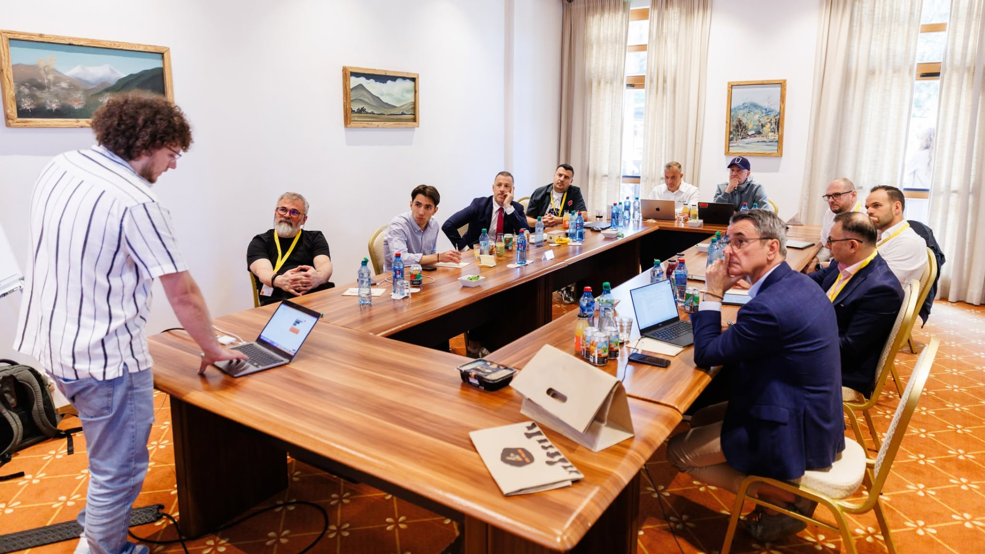 Investors and founders reviewing an investment case around a boardroom table.